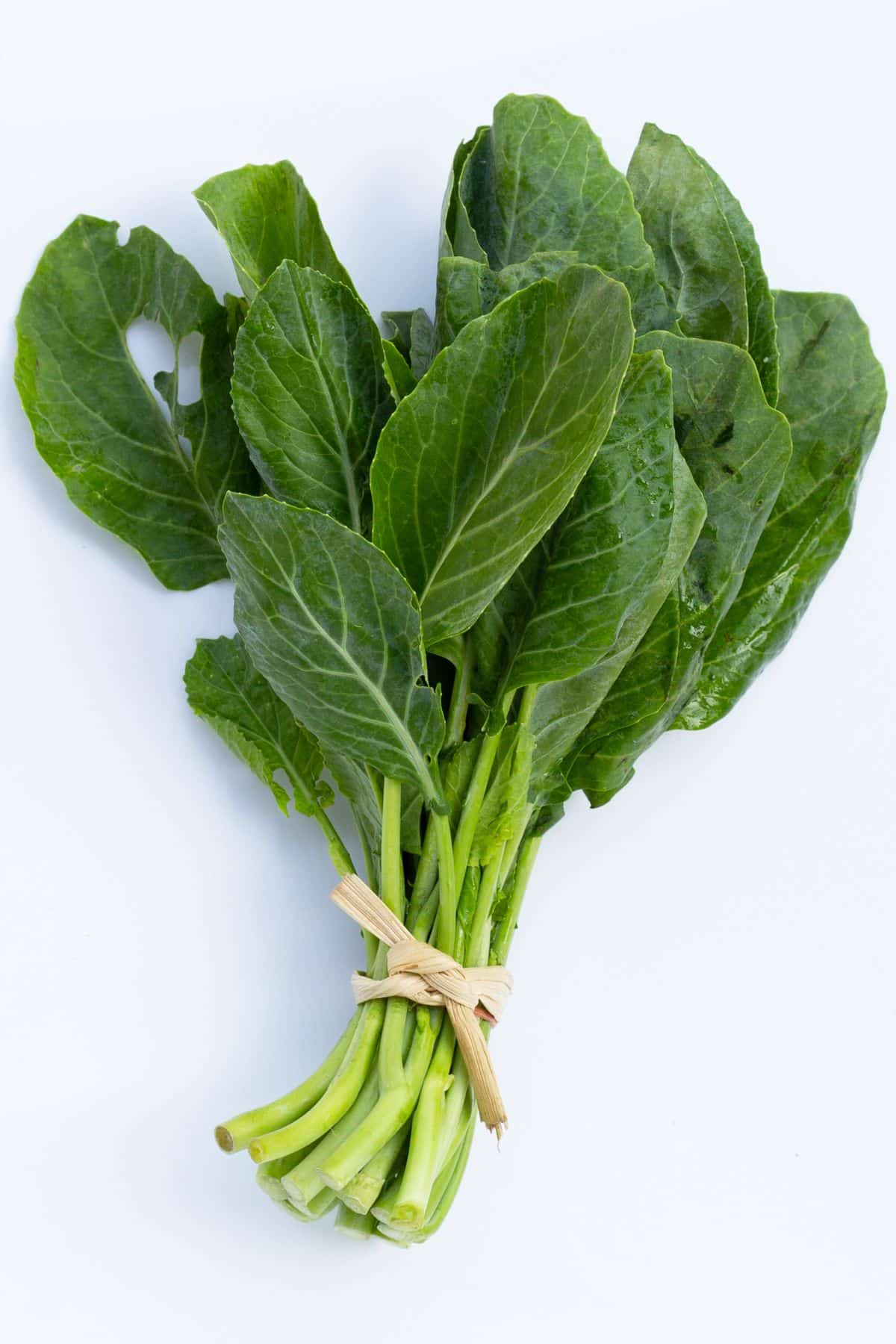 Bunch of collard greens on white background.