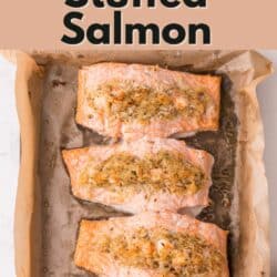 Costco copycat stuffed salmon filets in a parchment lined baking dish.
