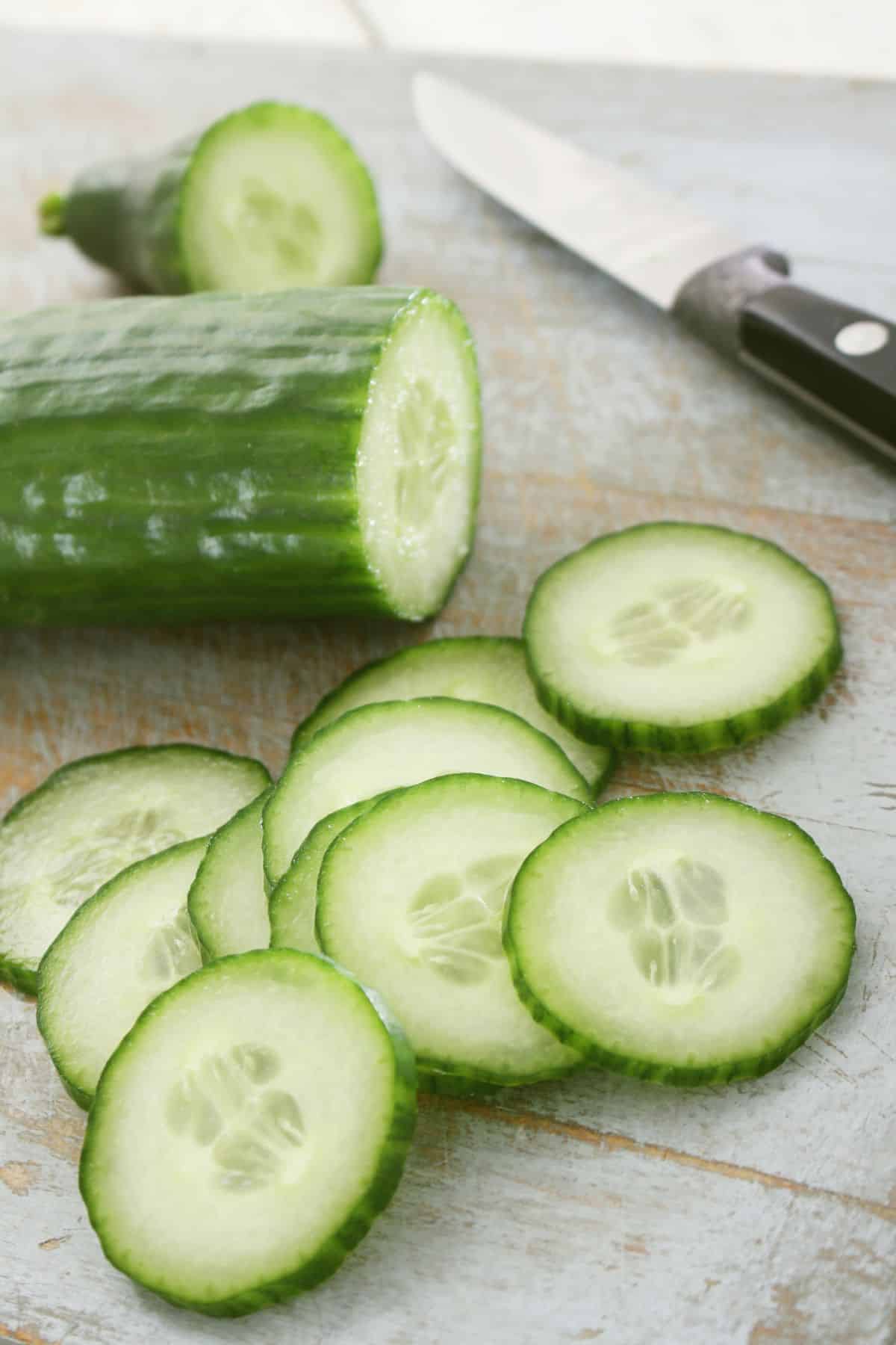 cucumber on table with knife.
