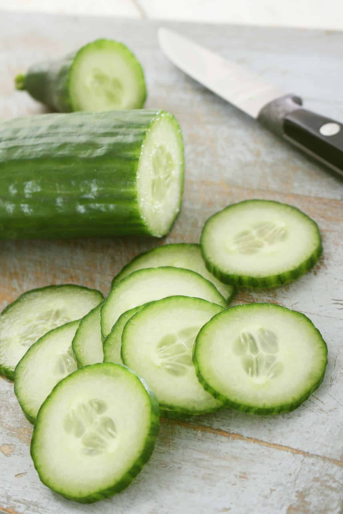 cucumber on table with knife.