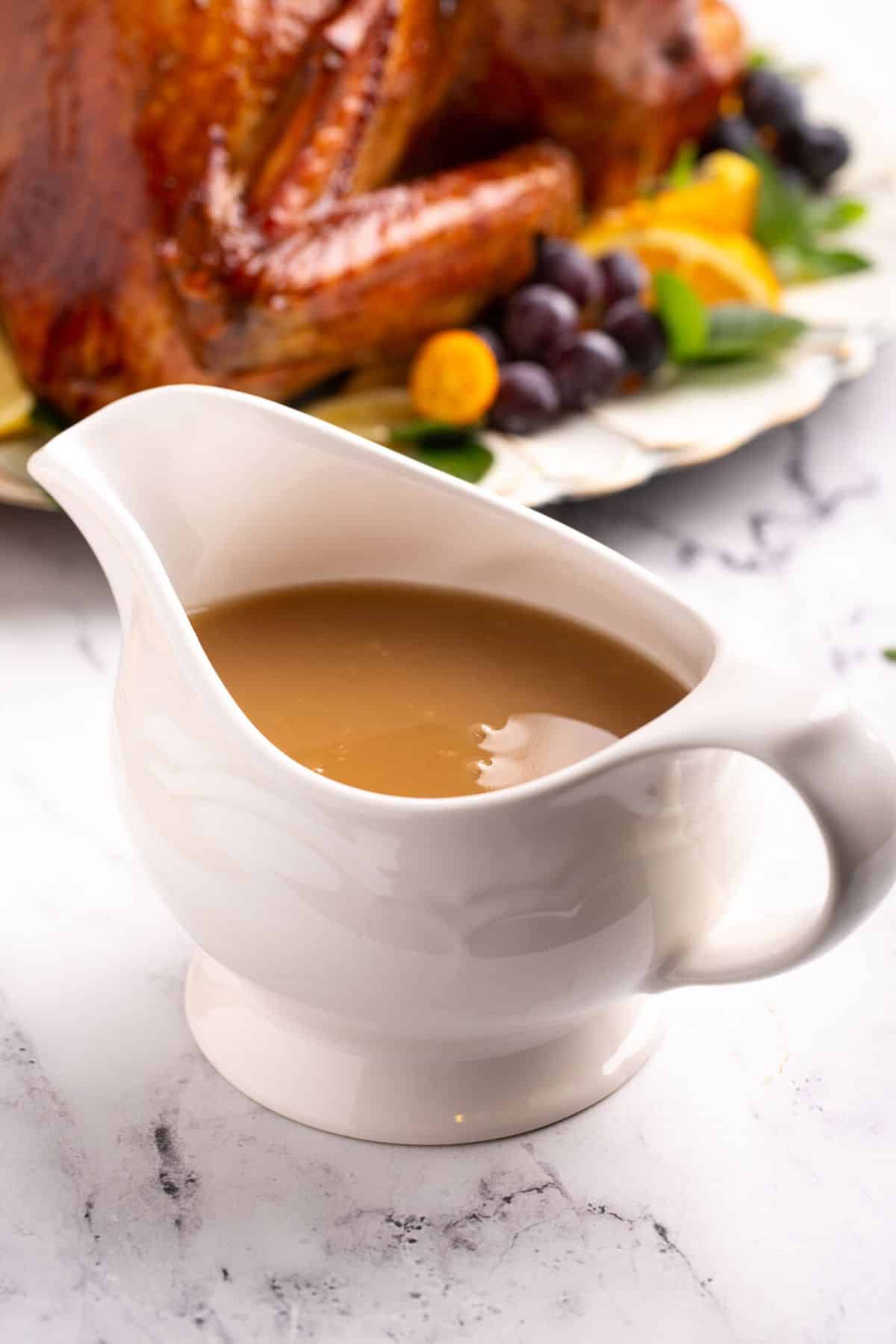 A white gravy boat filled with homemade dairy-free turkey gravy.
