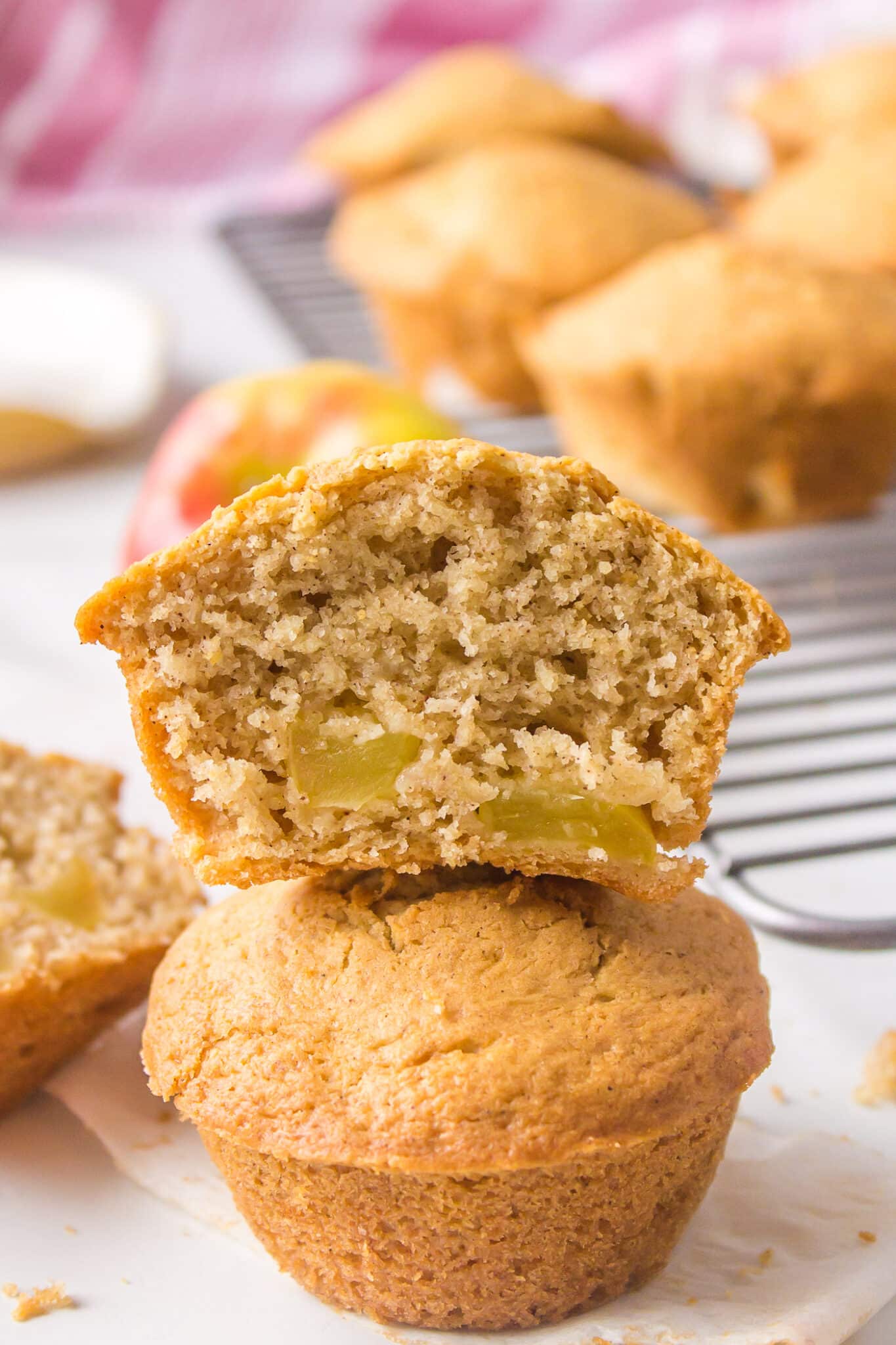 A halved apple muffin stacked on a whole muffin.