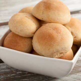 Gluten free and dairy free dinner rolls in a square dish.