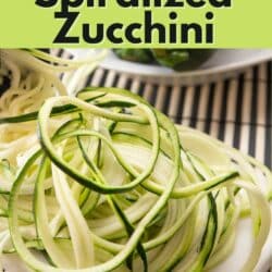 Spiralized zucchini piled on a small plate.