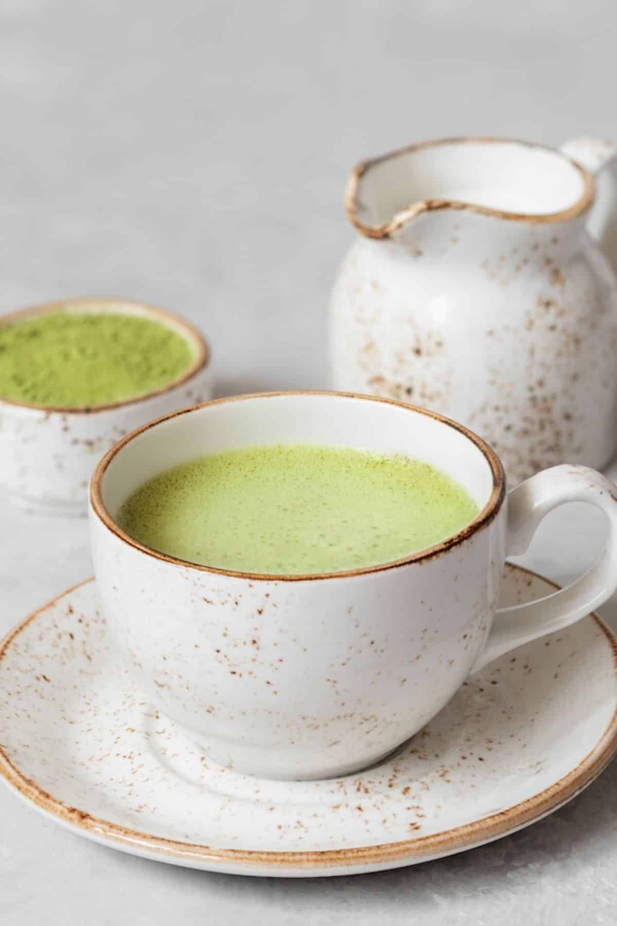coconut matcha latte in mug with coconut butter.