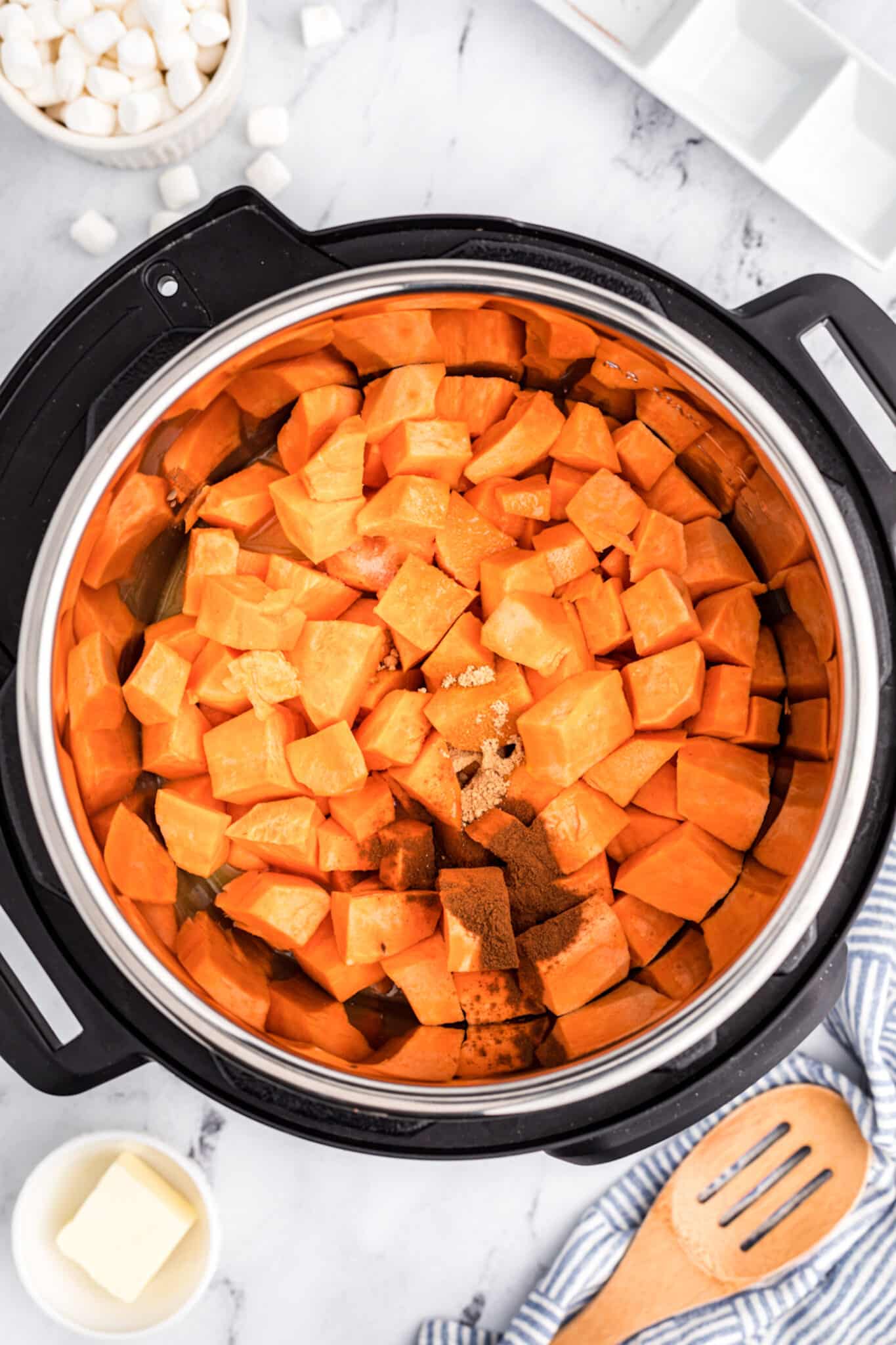 Diced yams in the insert of an Instant Pot.