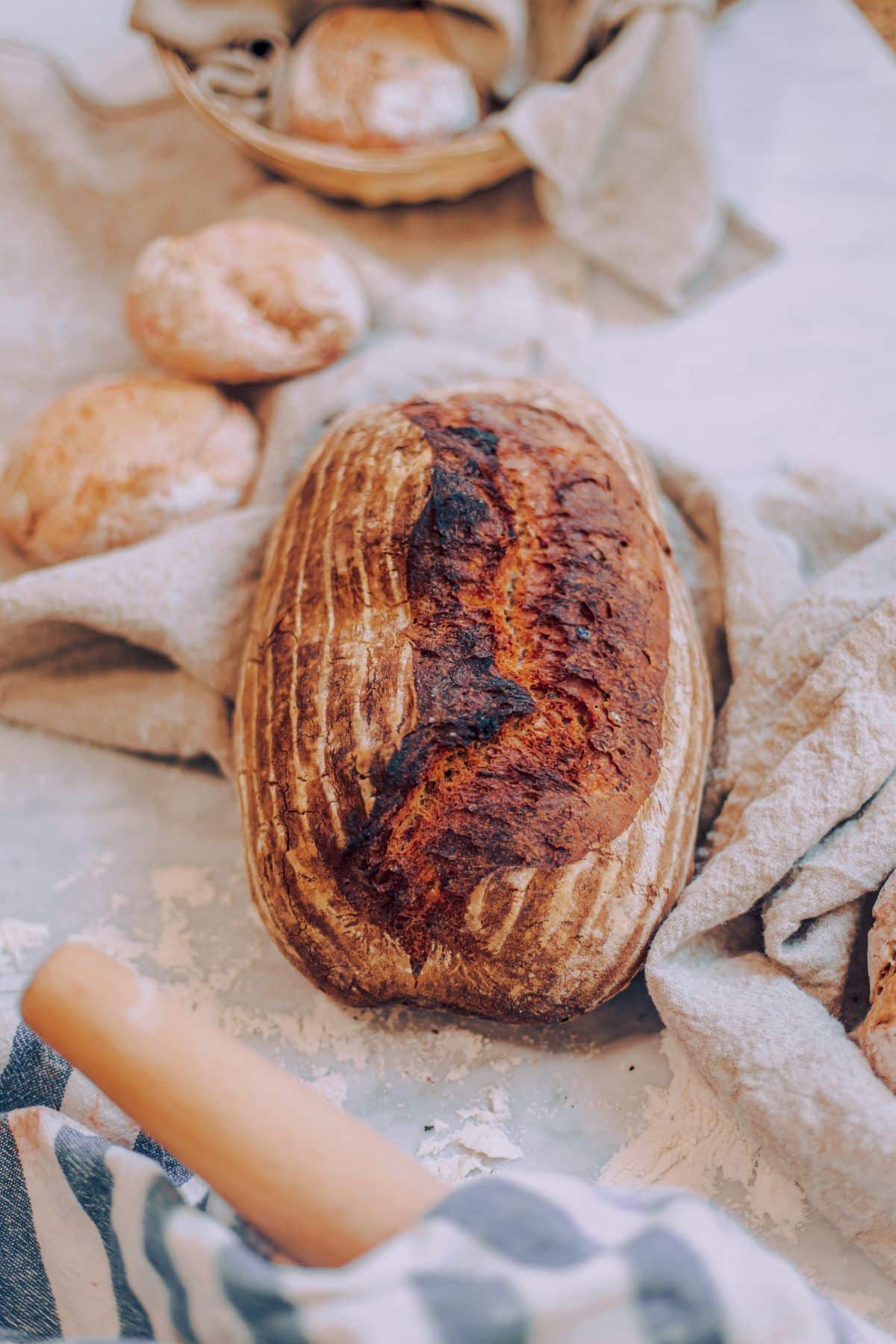 a loaf of sour dough bread on a table.