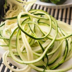 Spiralized zucchini in a pile on a counter.