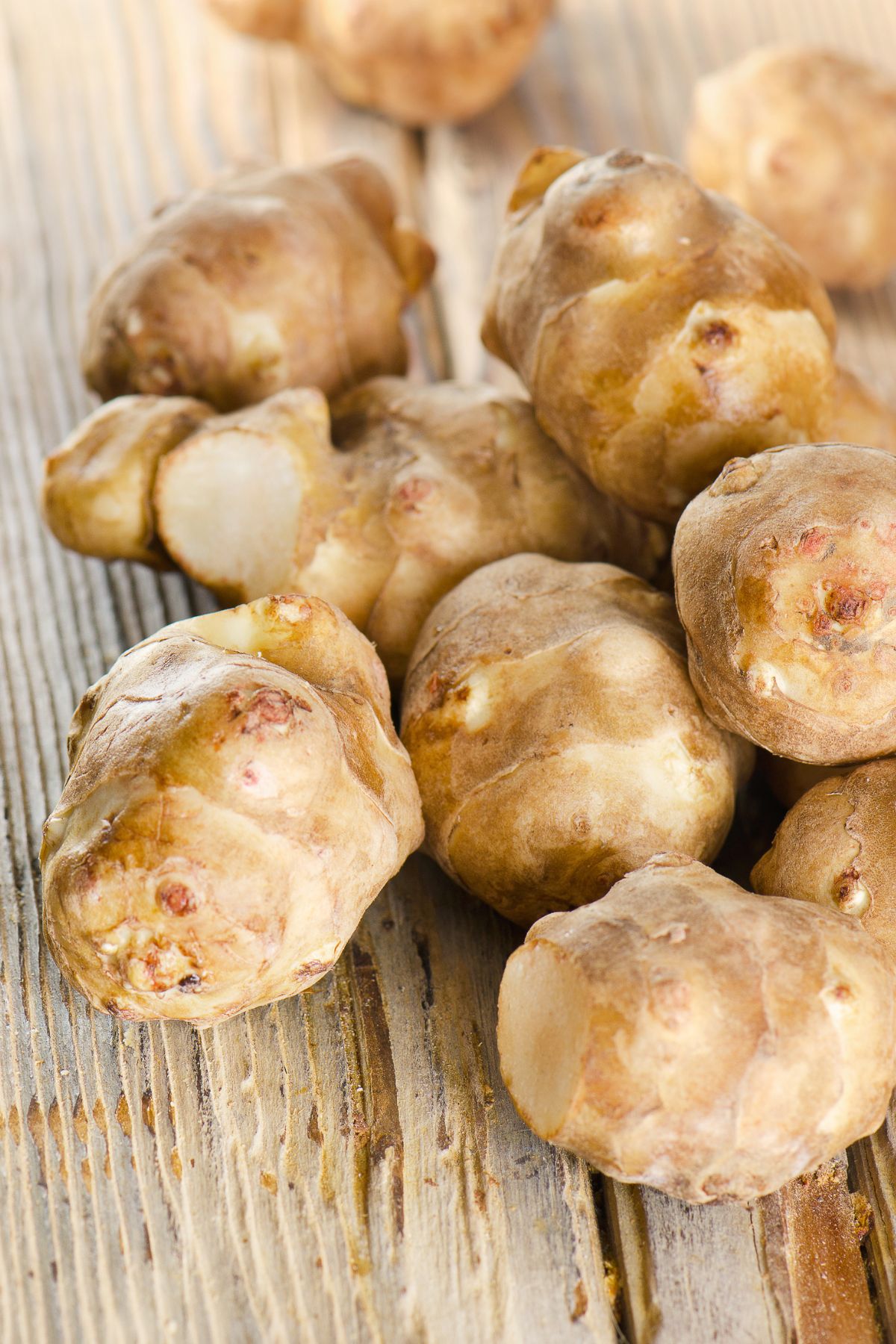 Jerusalem artichokes on a wooden table.