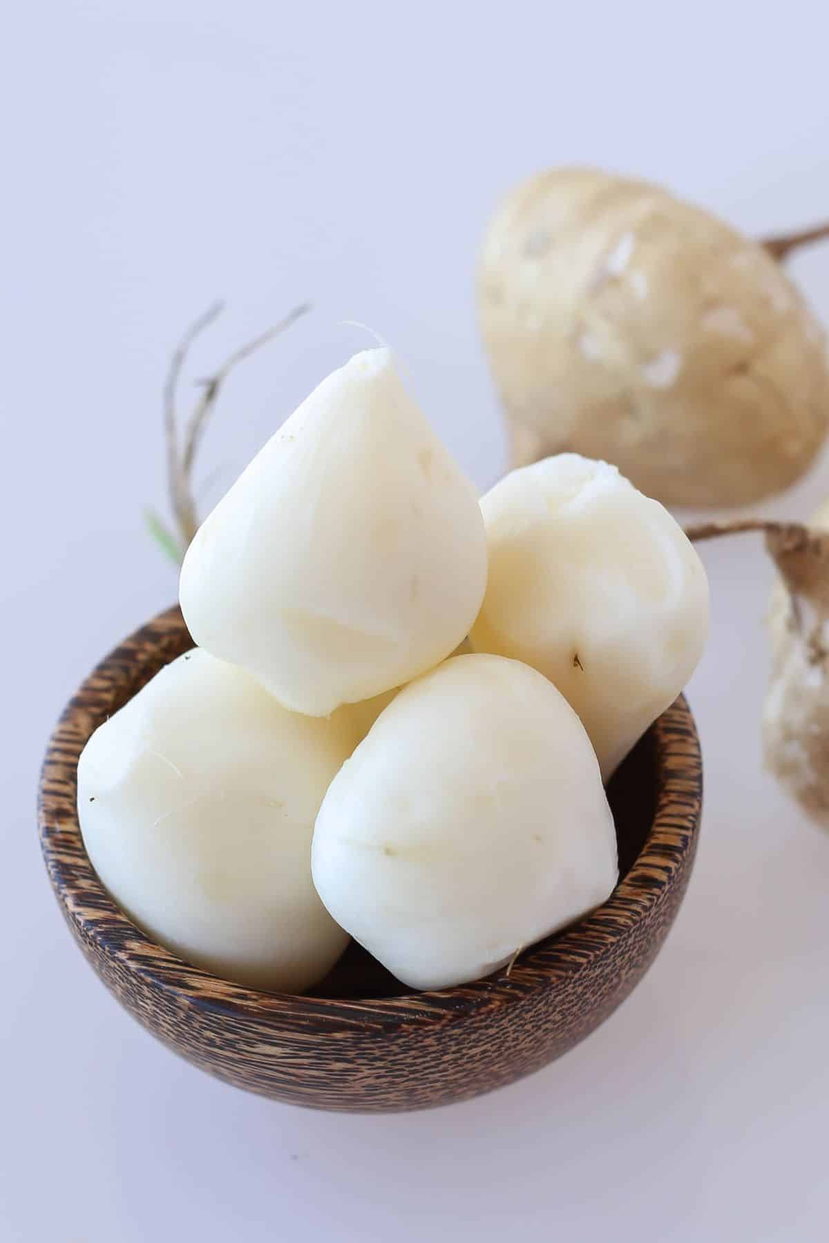 a wooden bowl full of jicama.