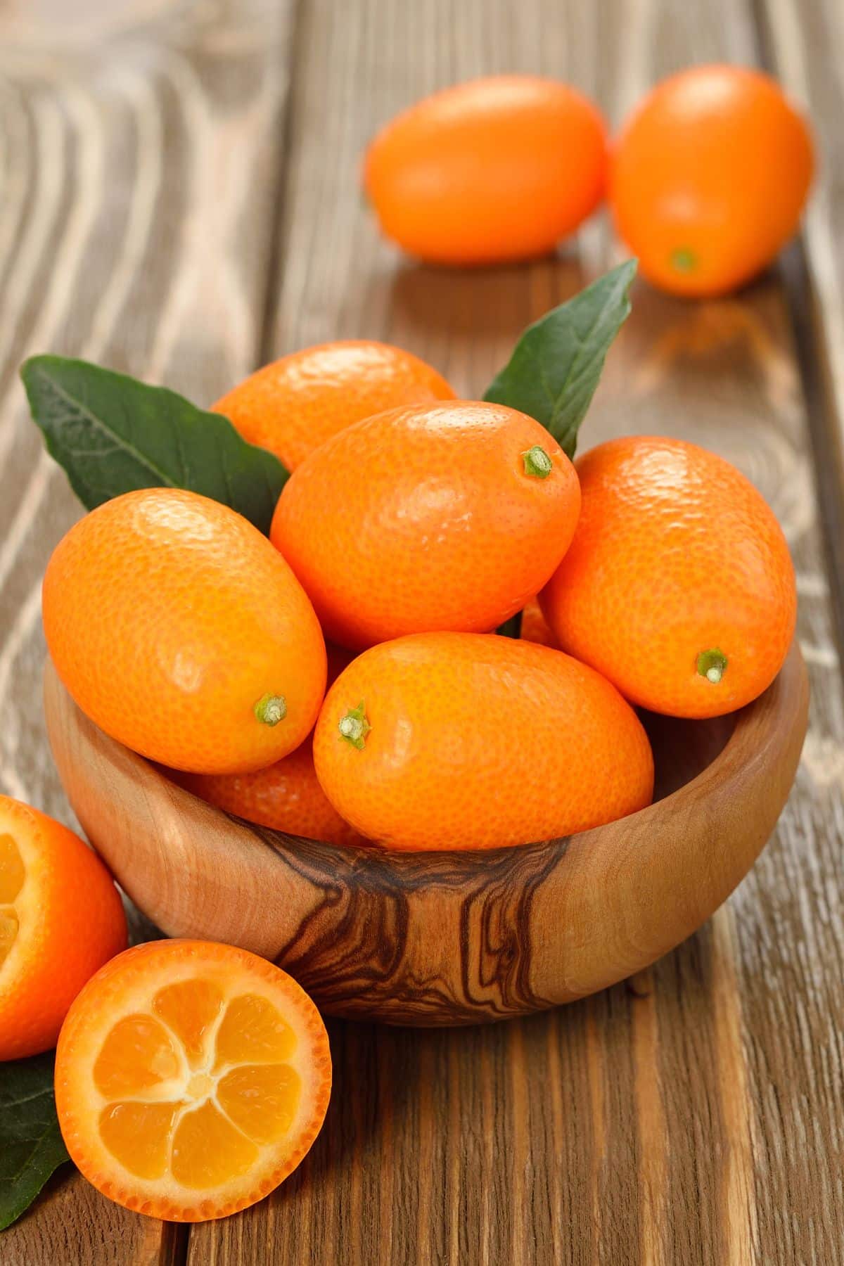 kumquats in a wooden bowl,