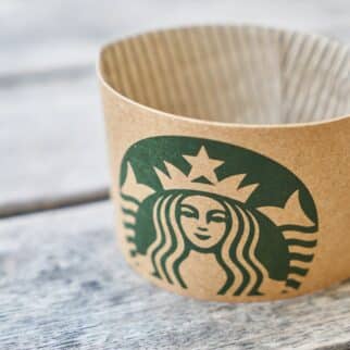 a Starbucks cup sleeve on a table.
