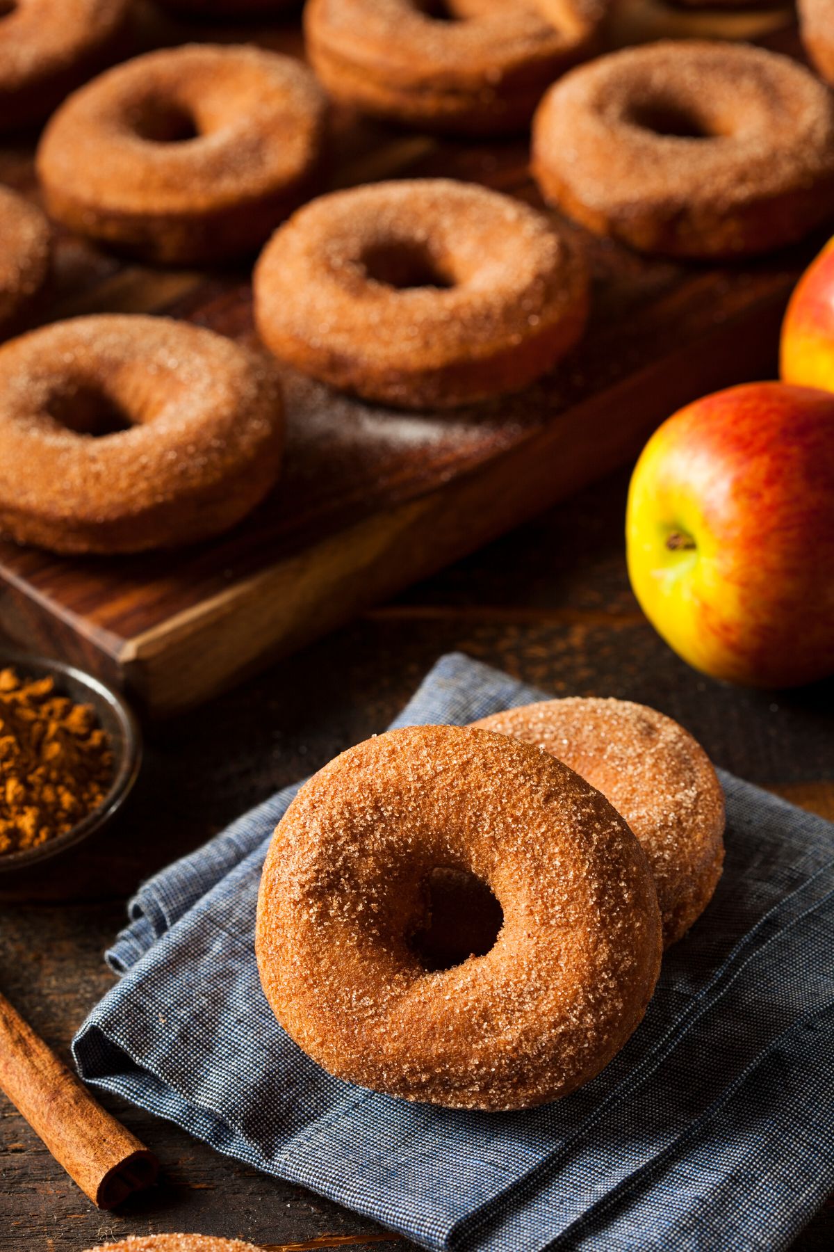 Apple cider donuts on a wooden board.