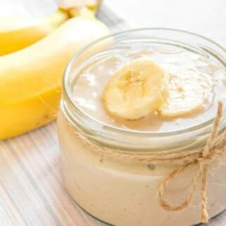 A squat jar filled with dairy-free banana pudding.