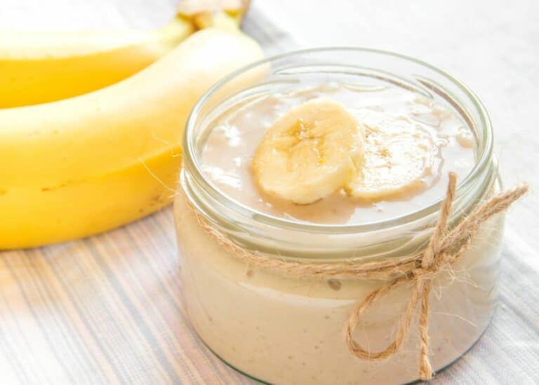 A squat jar filled with dairy-free banana pudding.