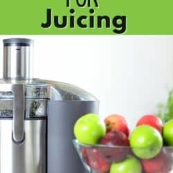 A juicer next to a bowl of red and green apples.