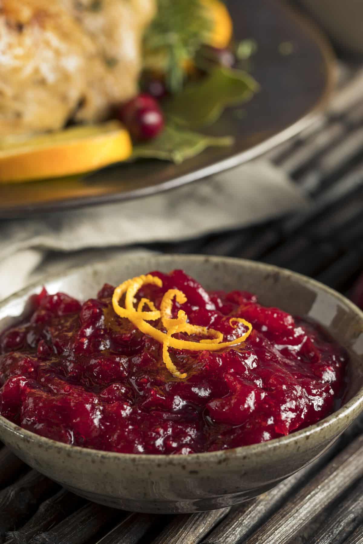 bowl of cranberry sauce on holiday table.