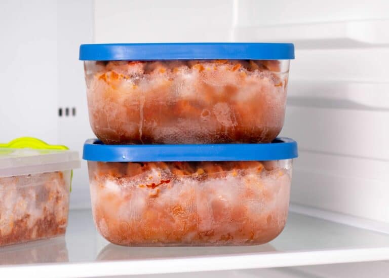 Frozen beef stew in square containers with blue lids.