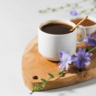 Mug of herbal coffee on a wooden board.