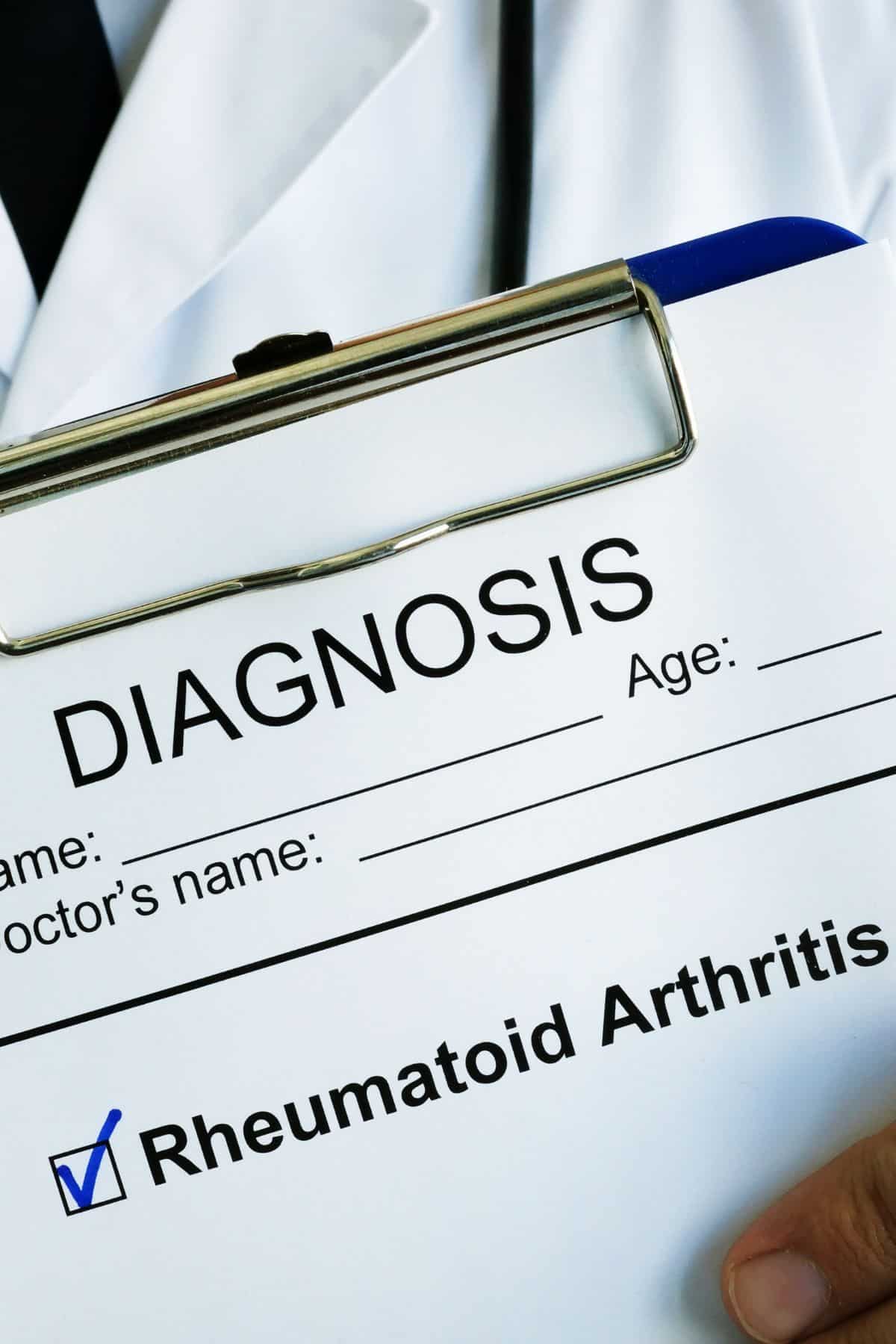a doctor holding a clipboard showing a diagnosis of rheumatoid arthritis.