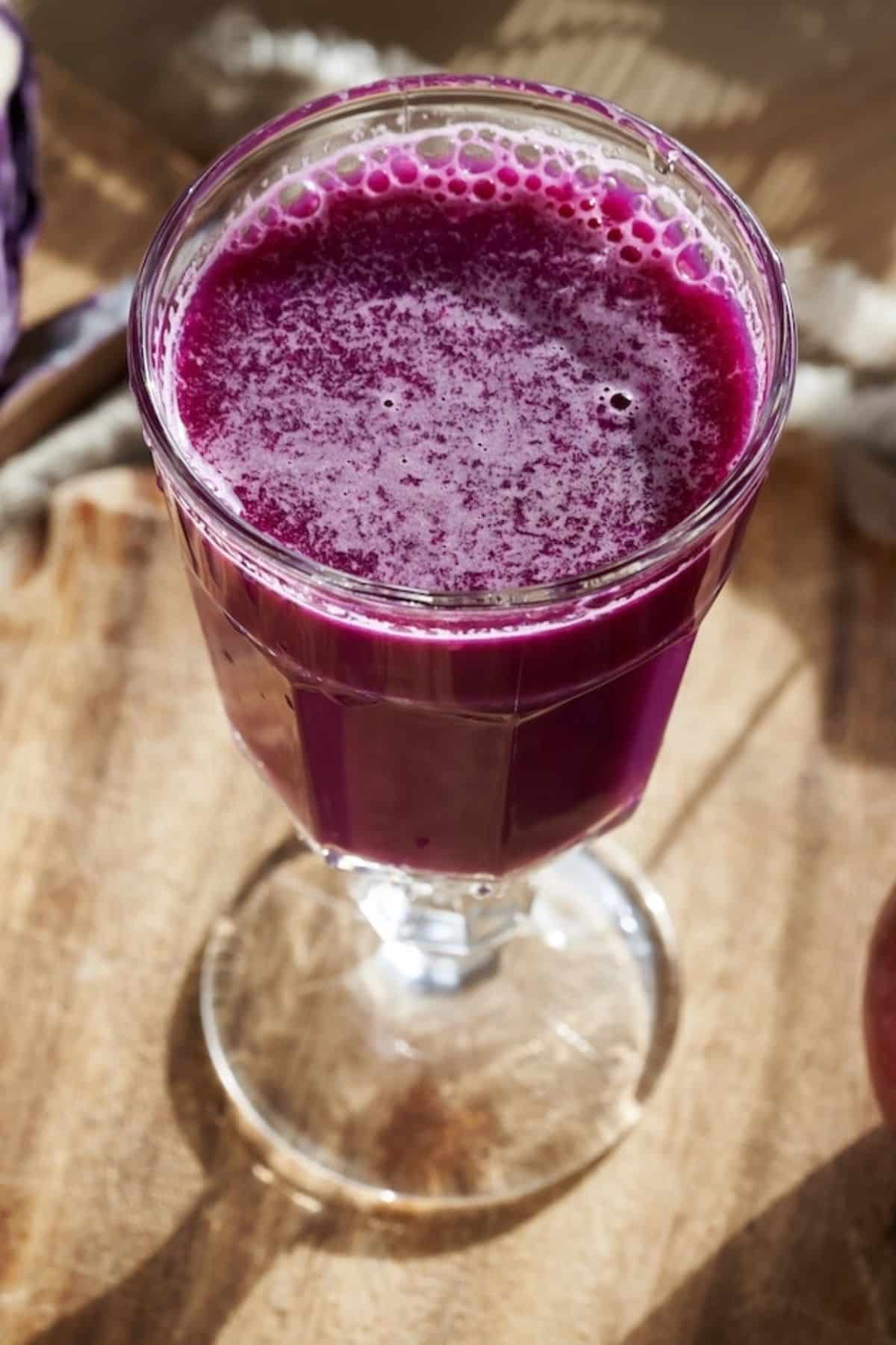 A tall glass of red cabbage juice.