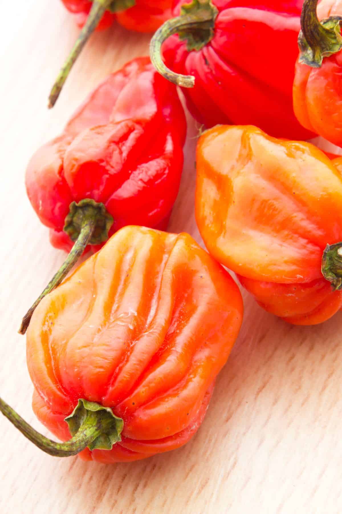 several habanero peppers on a table.