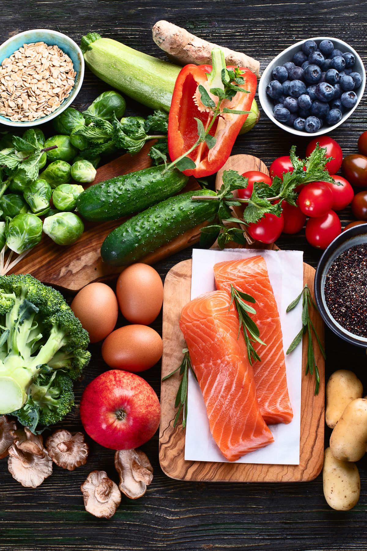 colorful display of healthy foods on a dark wood table.