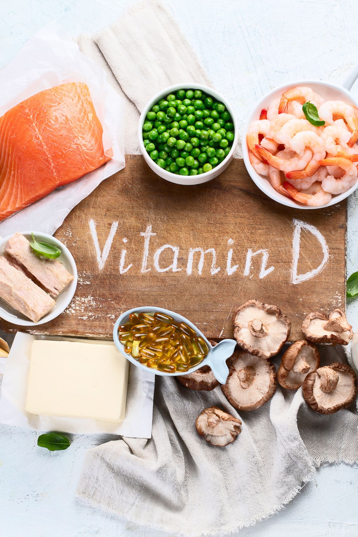 foods that are a good source of vitamin D surrounding a board saying "vitamin D."