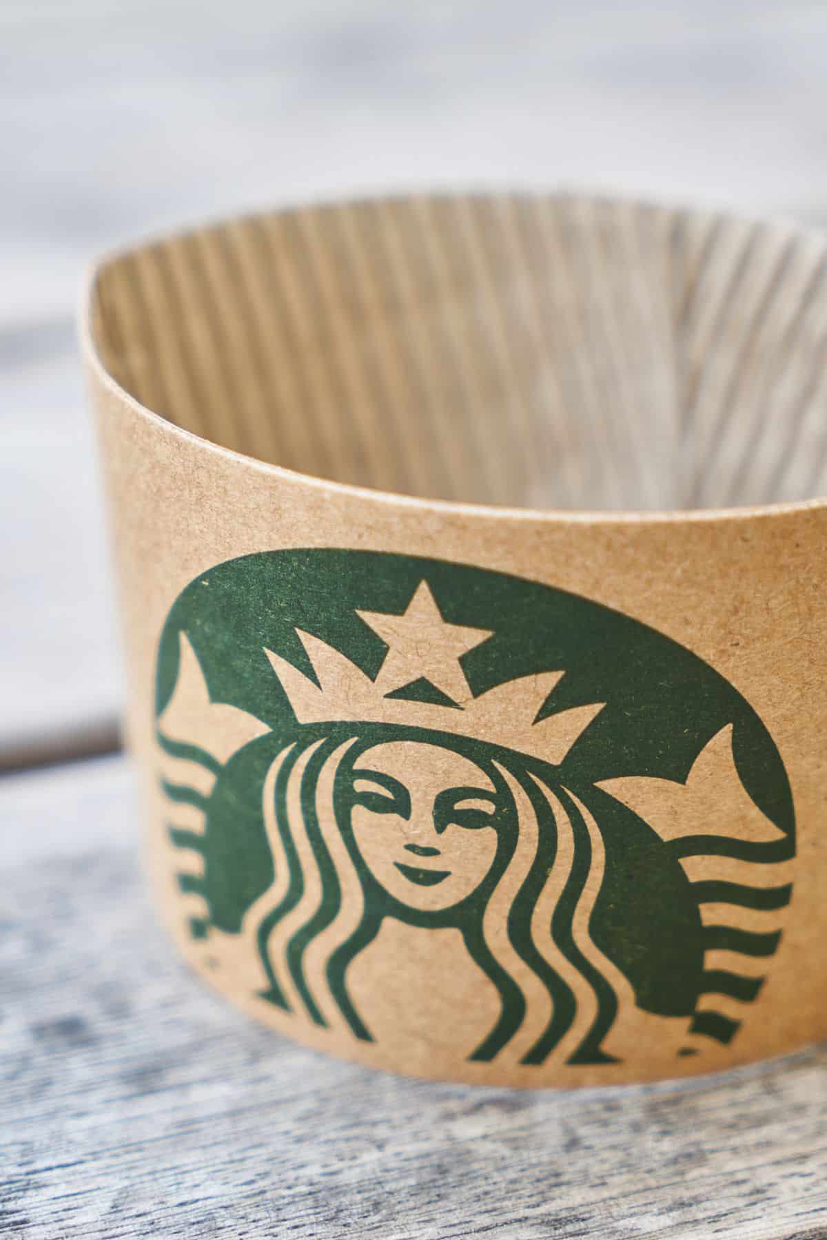 a Starbucks cup sleeve on a table.