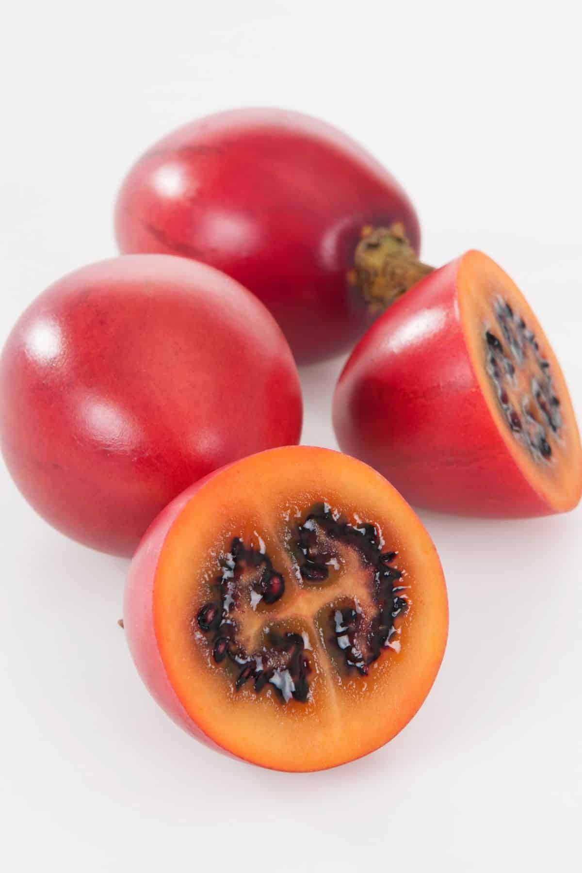 Several tamarillo on a white background.