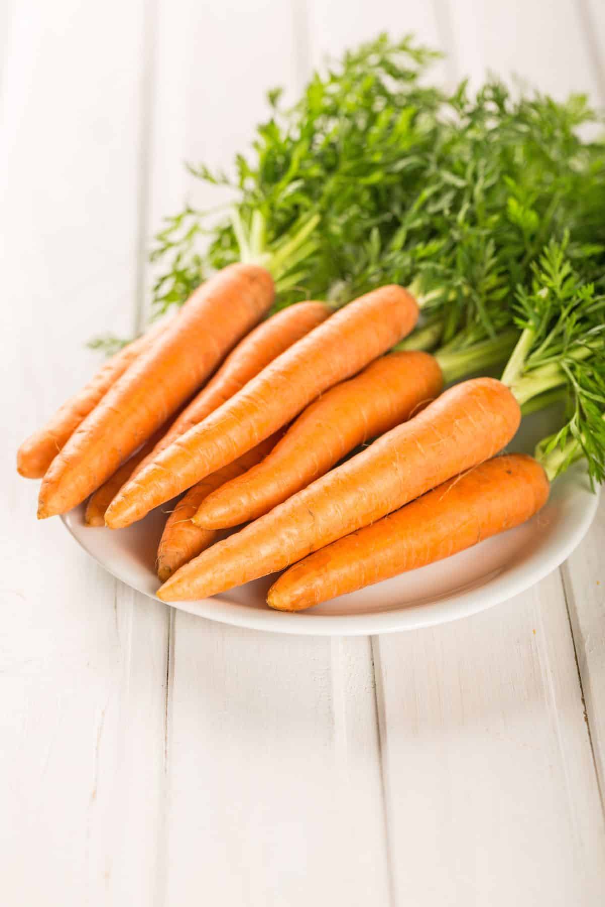 a bunch of carrots on a white plate.
