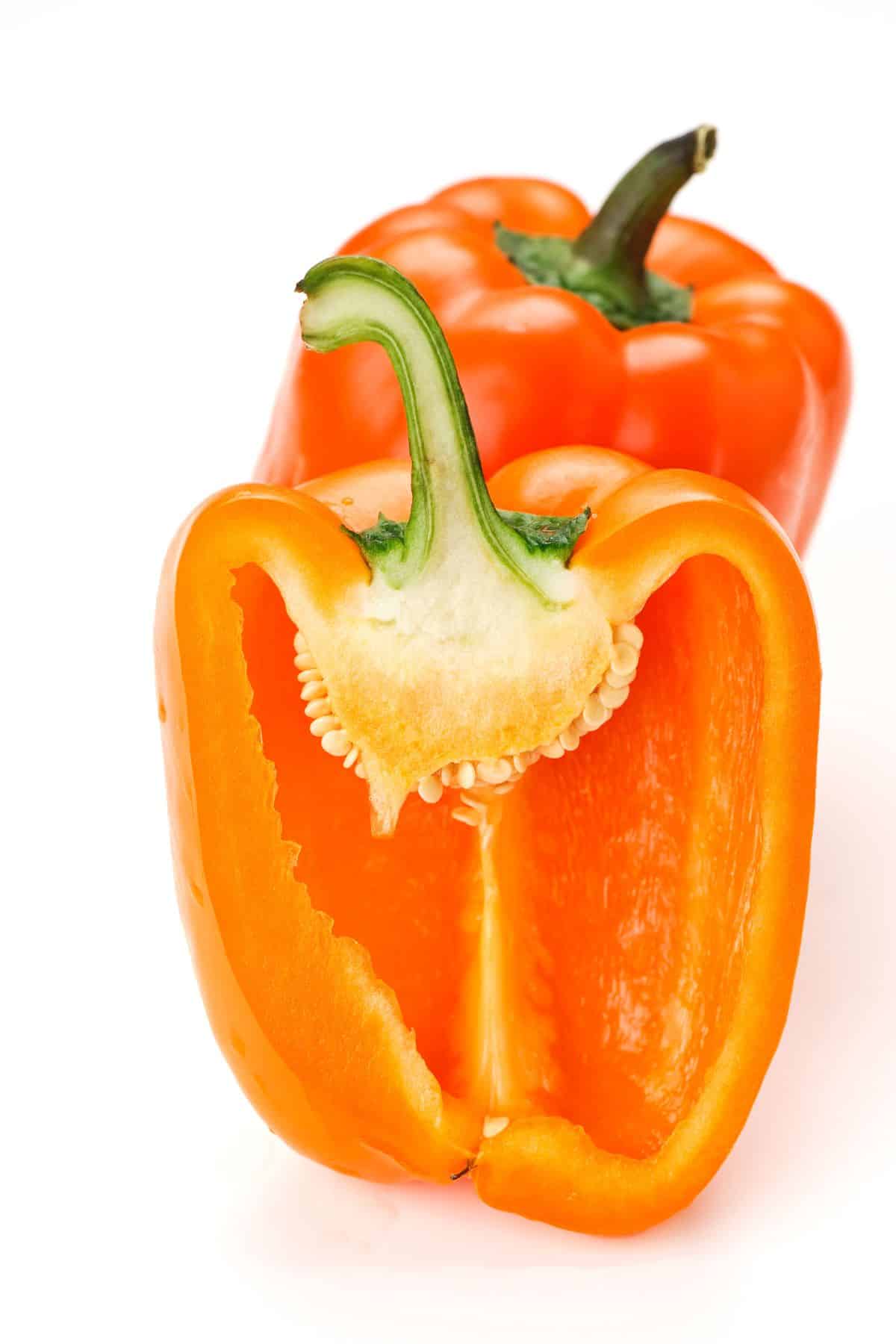 an orange bell pepper sliced in half.