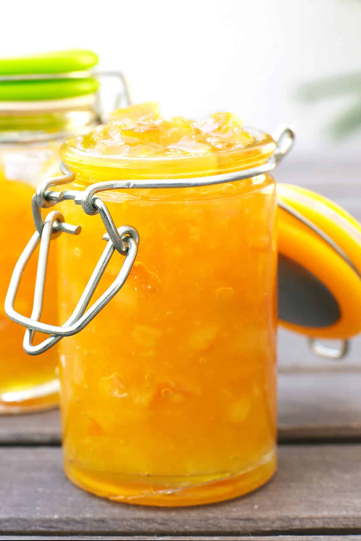 A flip top jar of orange marmalade.