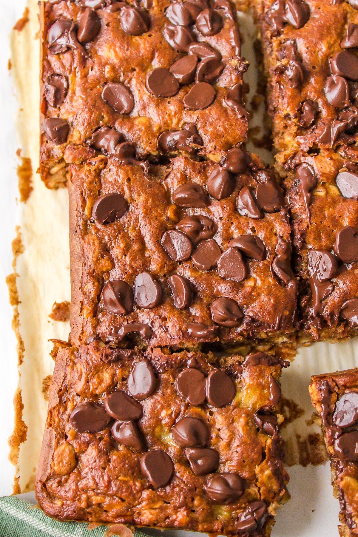 Closeup of sliced oatmeal banana bars on a metal sheet pan.