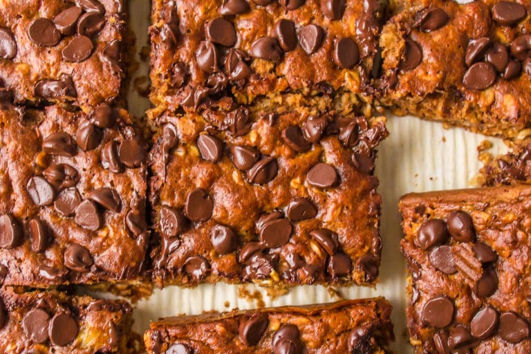 Closeup of sliced oatmeal banana bars on a metal sheet pan.