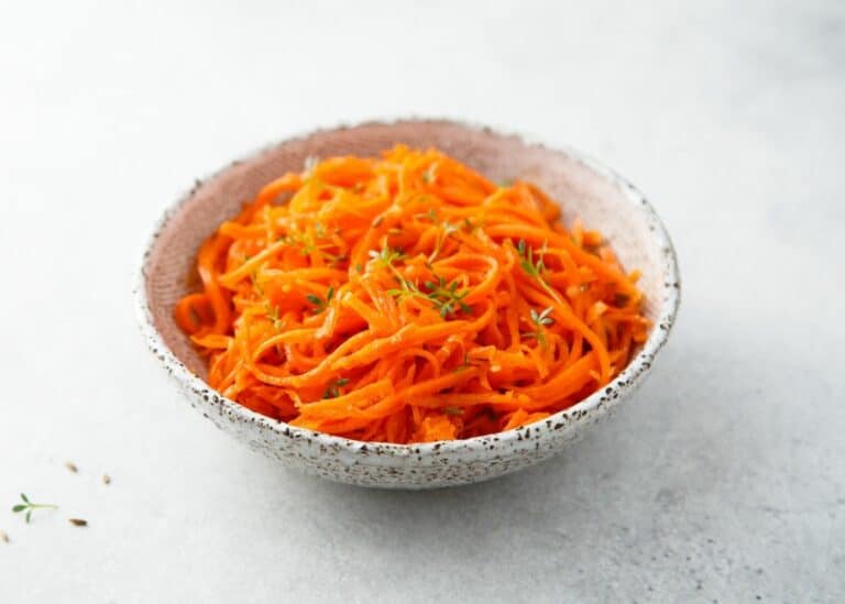 Shredded carrot salad topped with thyme.