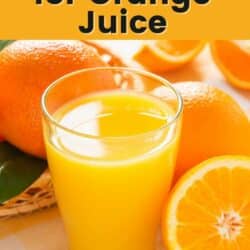 Fresh orange juice in a glass surrounded by whole oranges.
