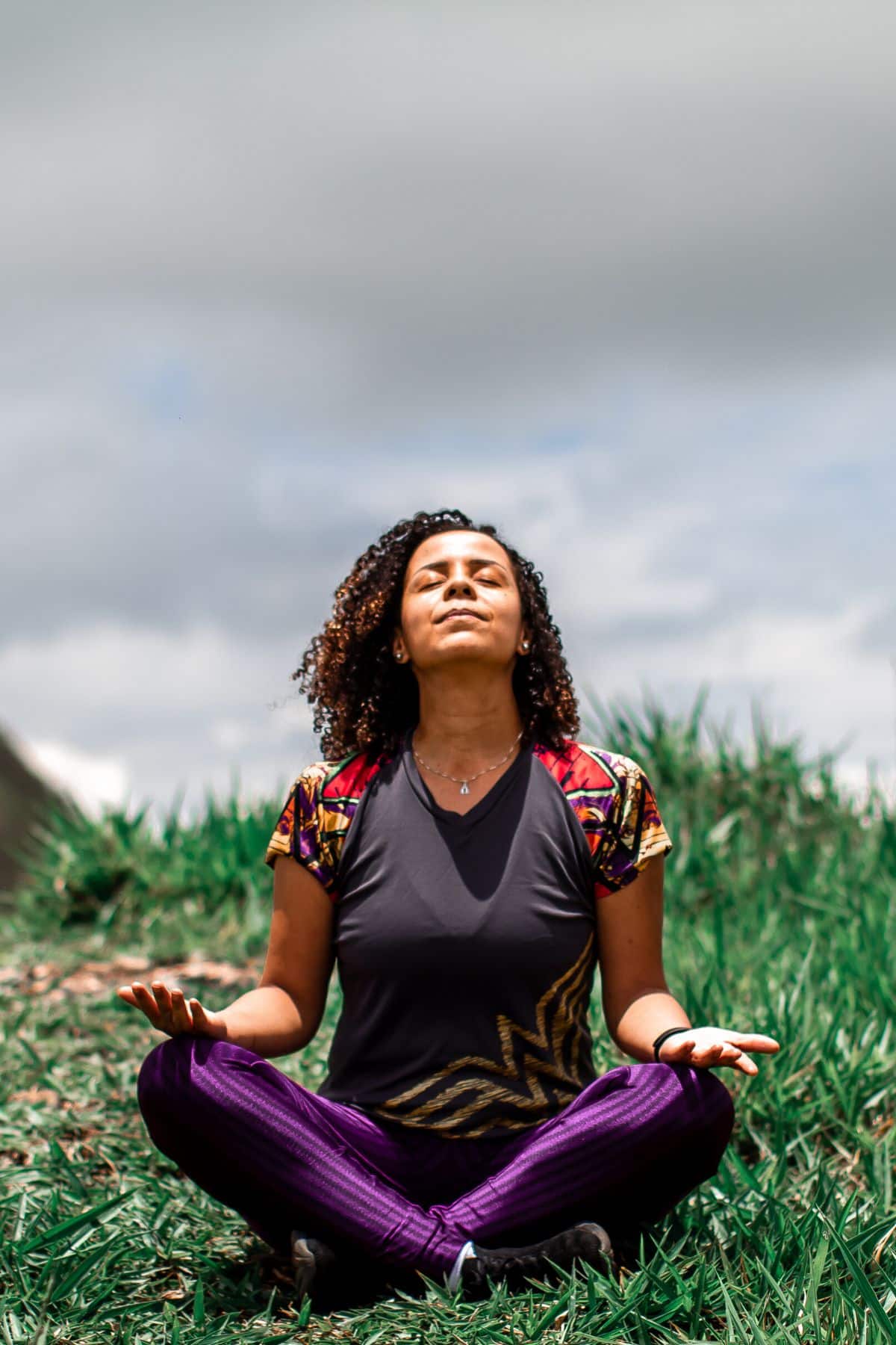 young woman meditating outside.