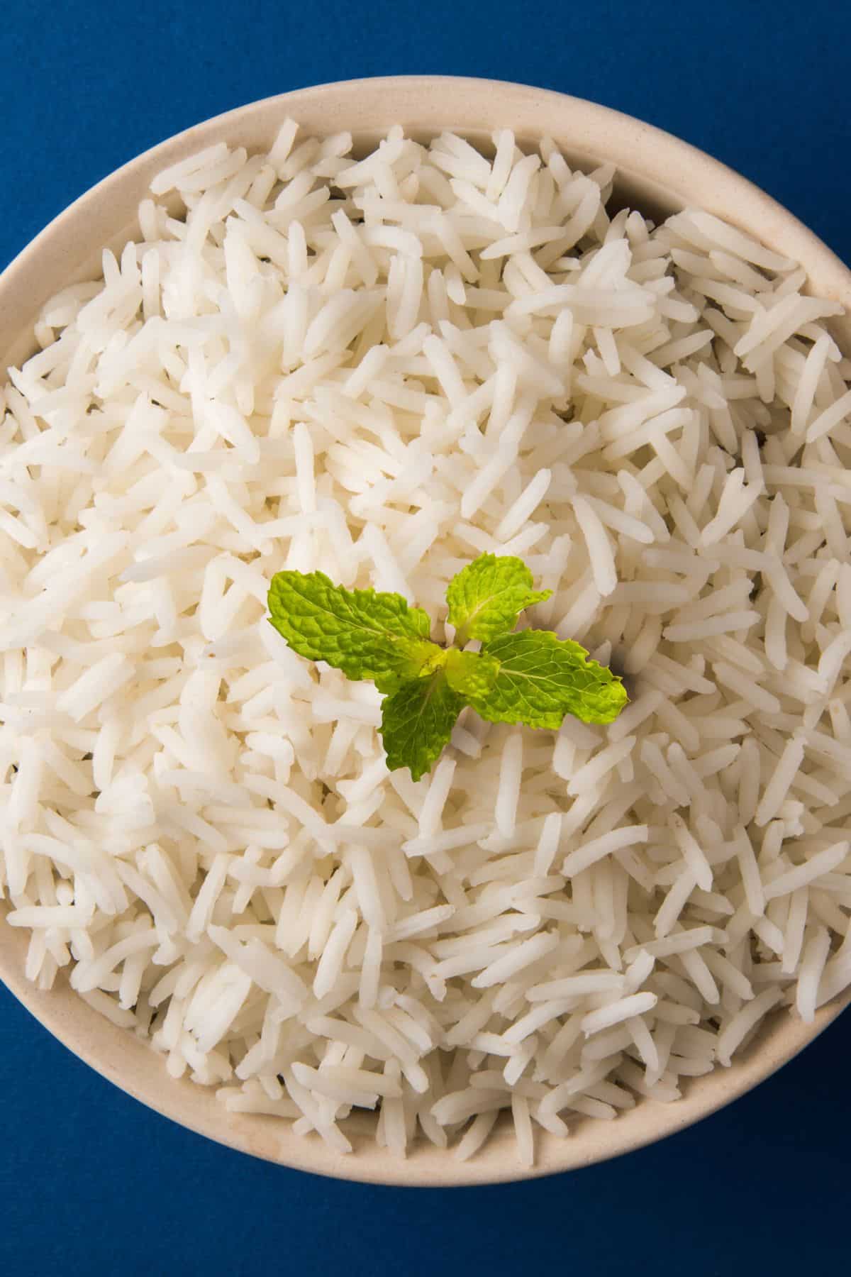 a white bowl of basmati rice.