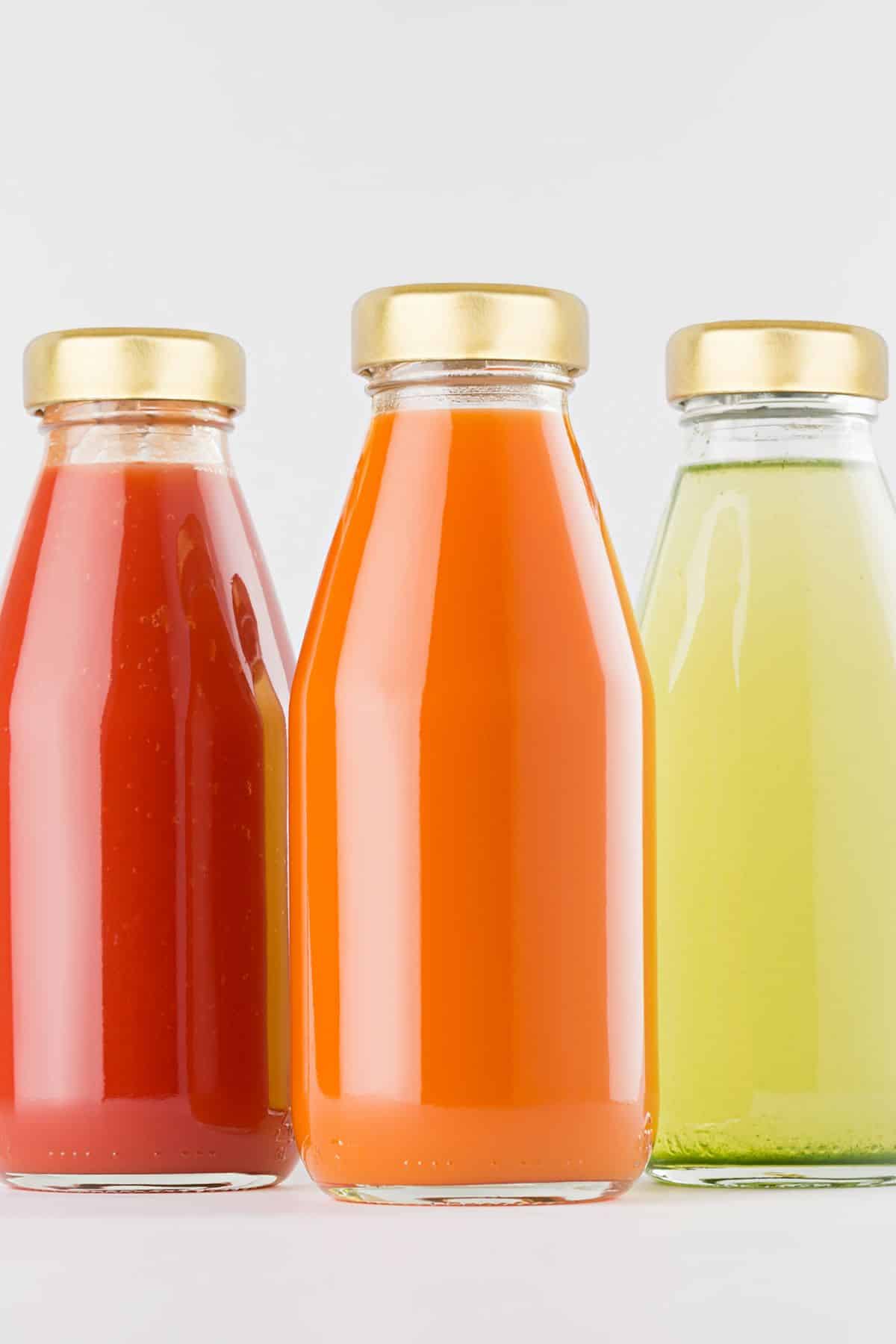 three bottles of various fruit juice concentrates.