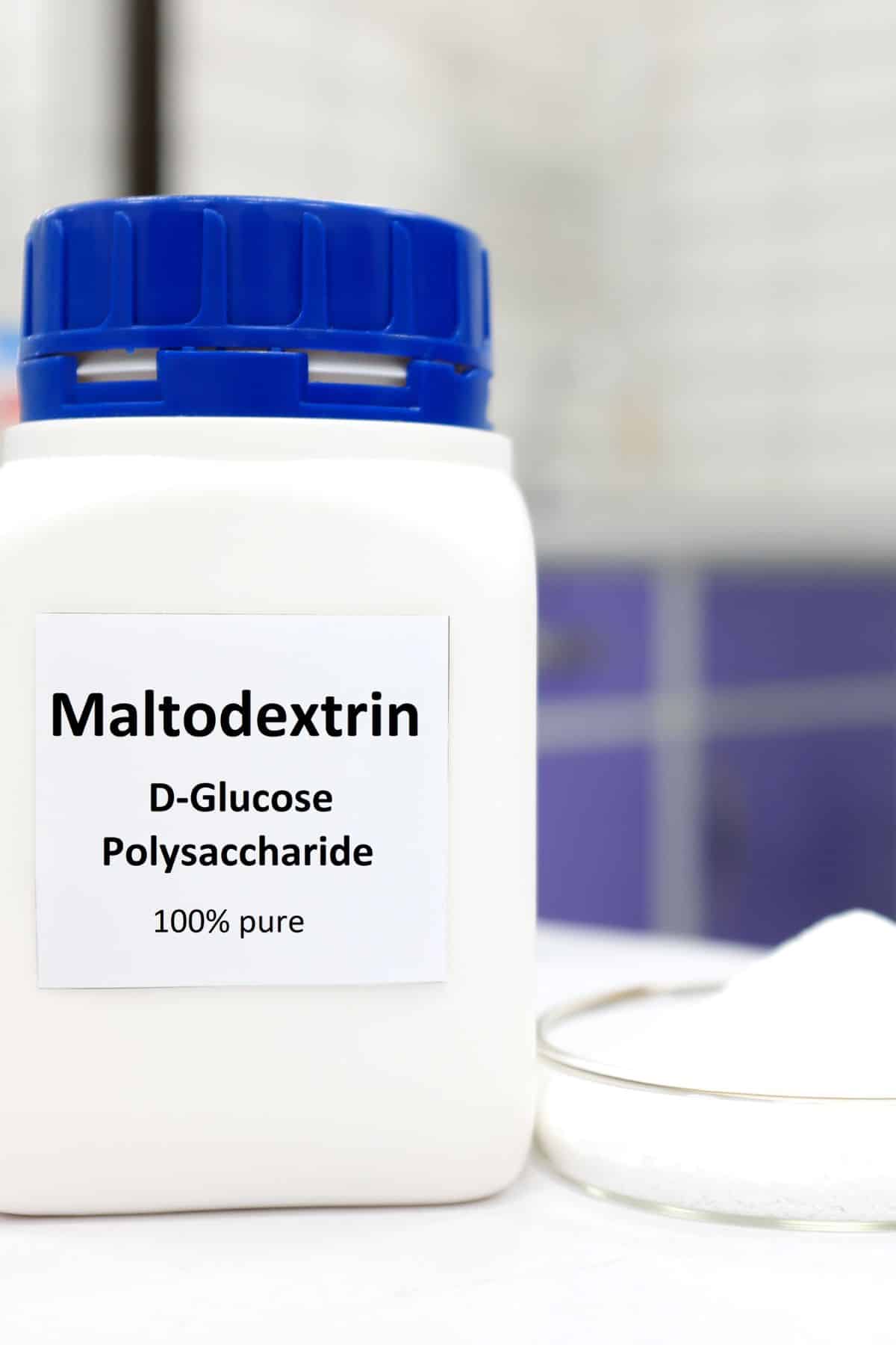 a bottle labeled "Maltodextrin" next to a beaker full of maltodextrin.