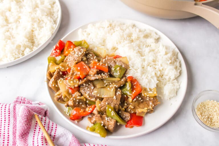 copycat P.F. Chang's Pepper Steak on a white plate with rice.