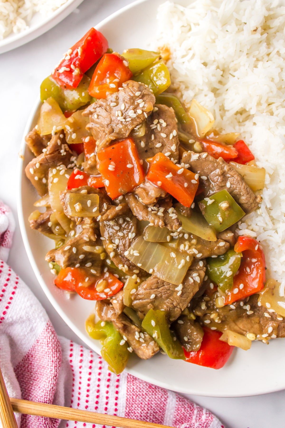 copycat P.F. Chang's Pepper Steak on a white plate with rice.