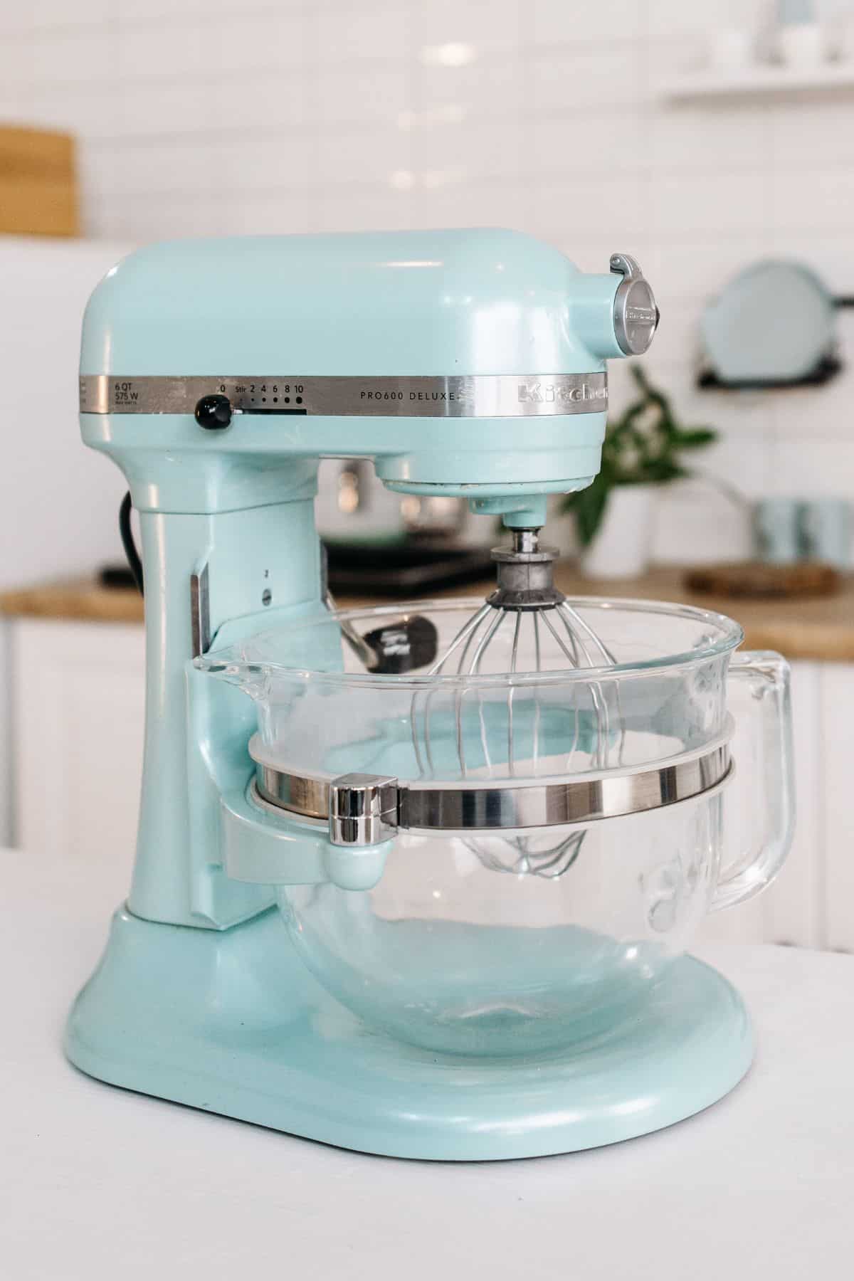 a blue stand mixer on a counter.