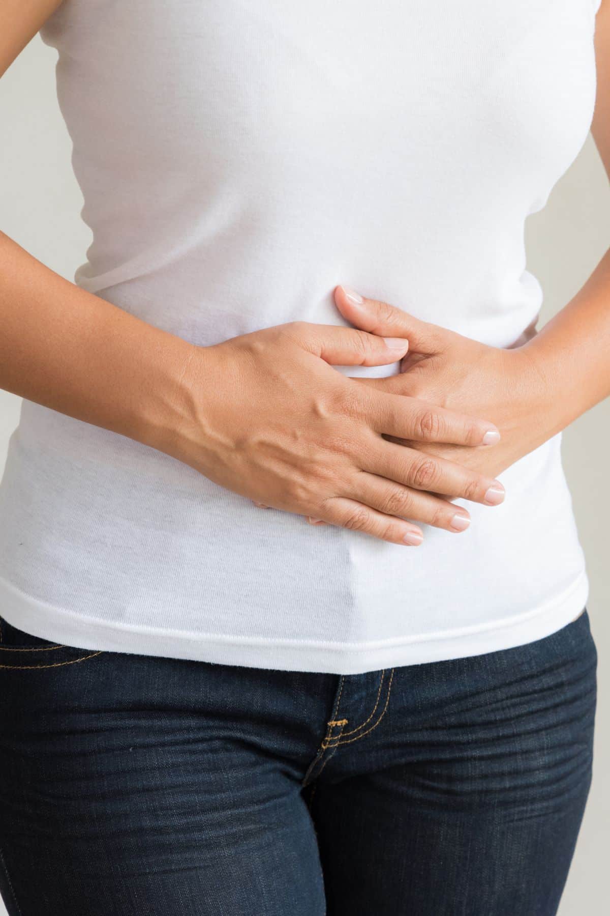 a woman holding her abdomen. 