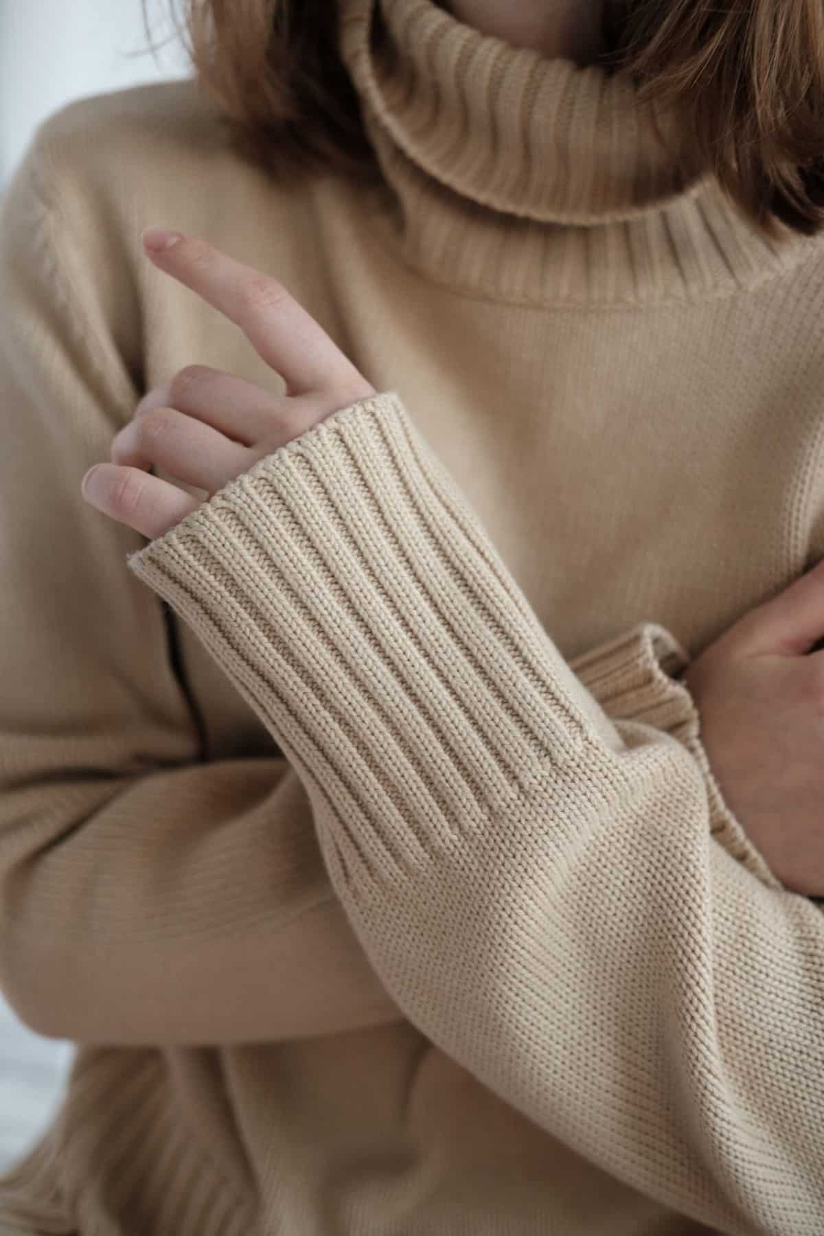 a woman covering her chest with her arms.