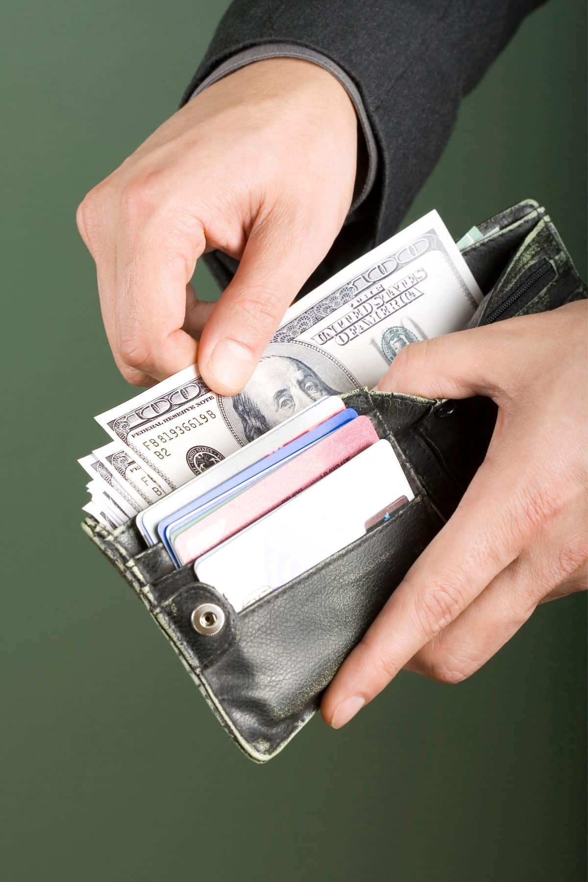 a person taking money from his wallet.