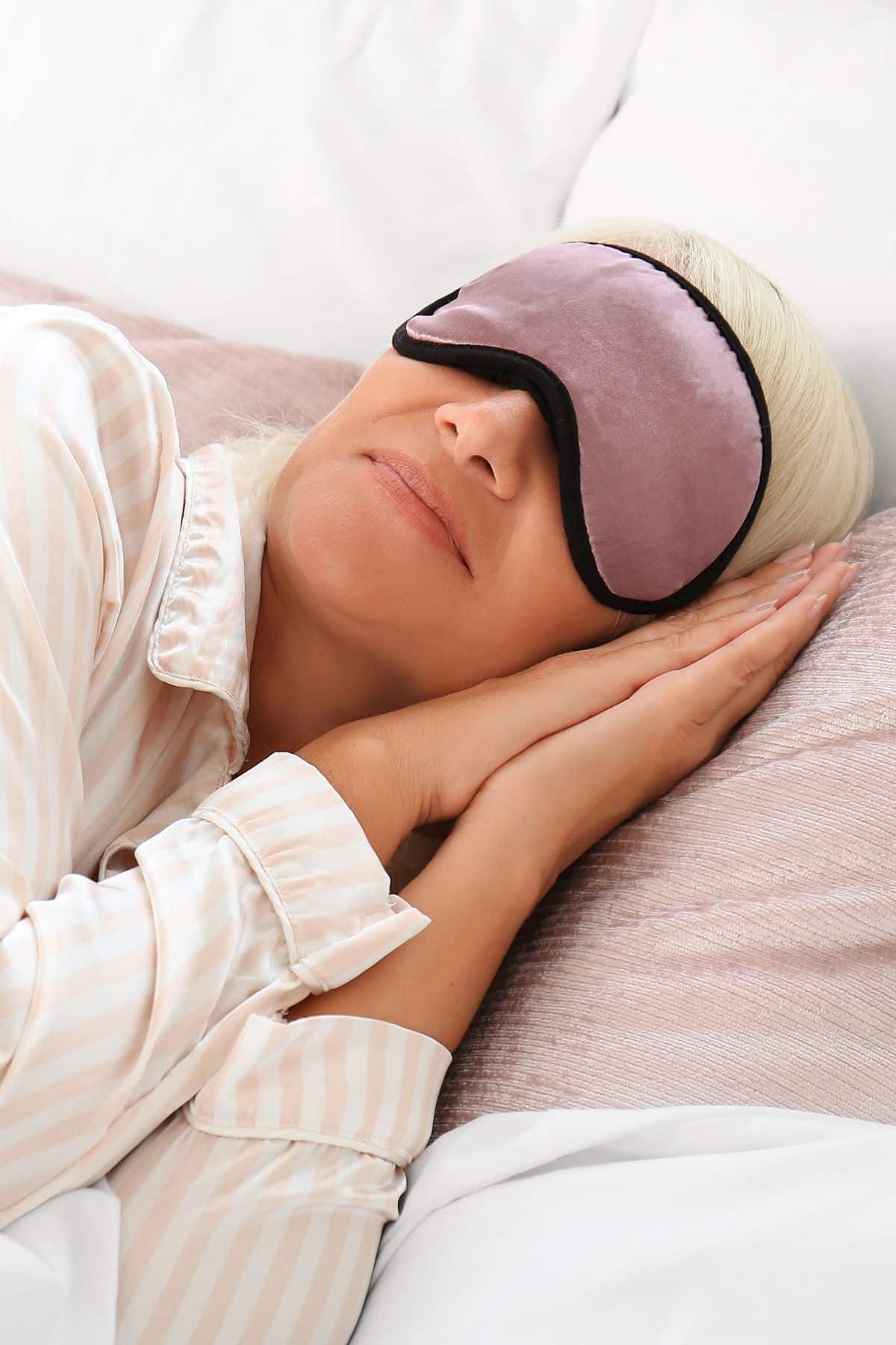 a woman sleeping with an eye mask.