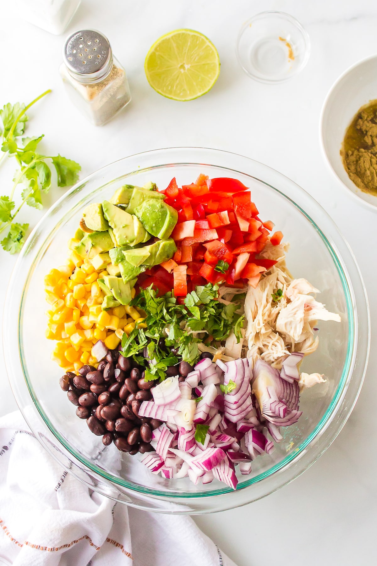 salad ingredients in a clear bowl.