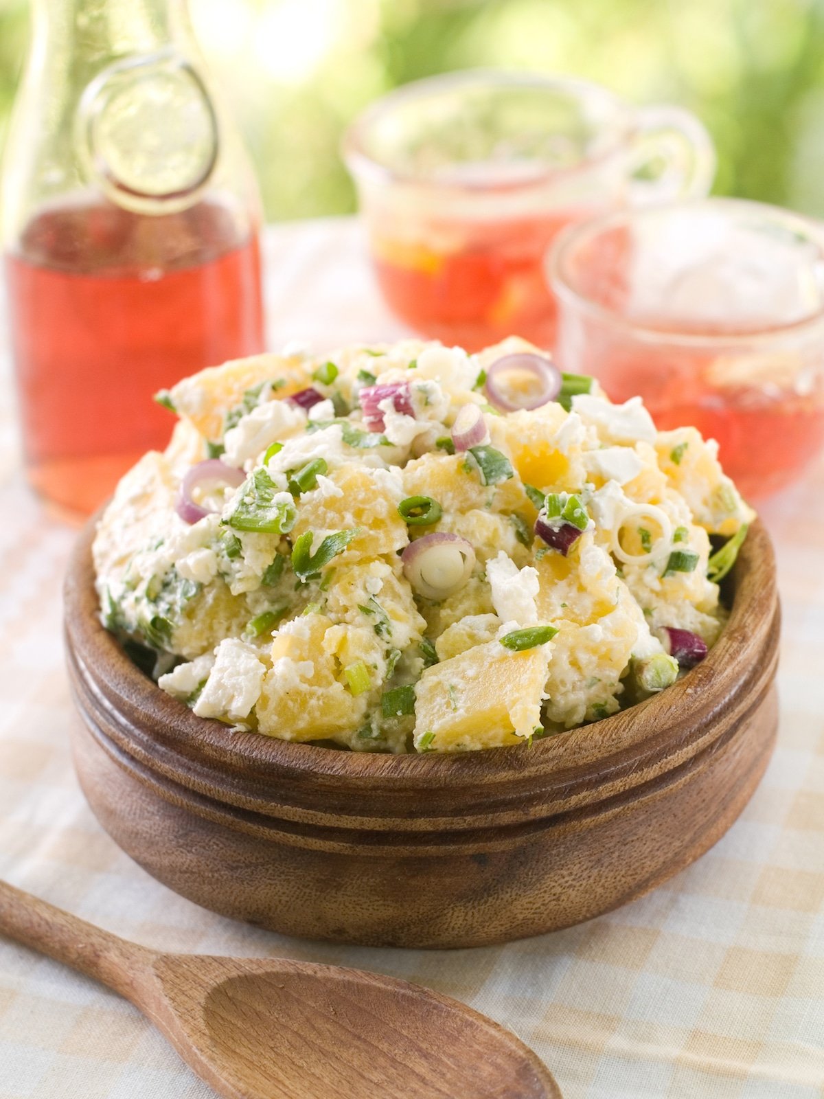 egg salad without eggs in wooden bowl on table with pink drink.